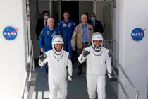 NASA astronauts Douglas Hurley, left, and Robert Behnken walk out of the Neil A. Armstrong Oper ...