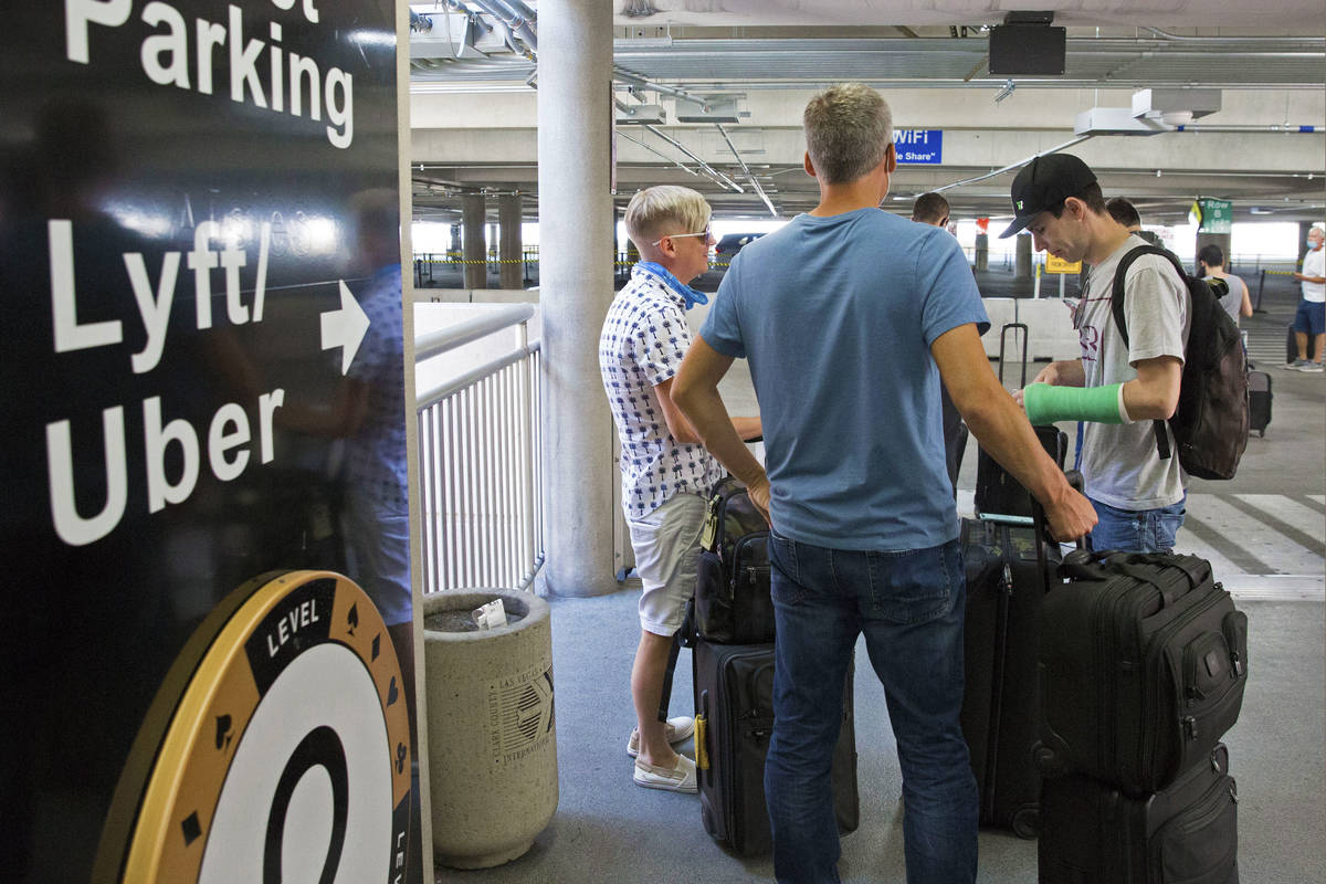 Arriving passengers wait for their ride at ride share waiting area at McCarran International Ai ...