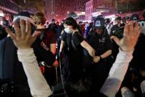 Police arrest protesters as they march through the streets of Manhattan, New York, Wednesday, J ...