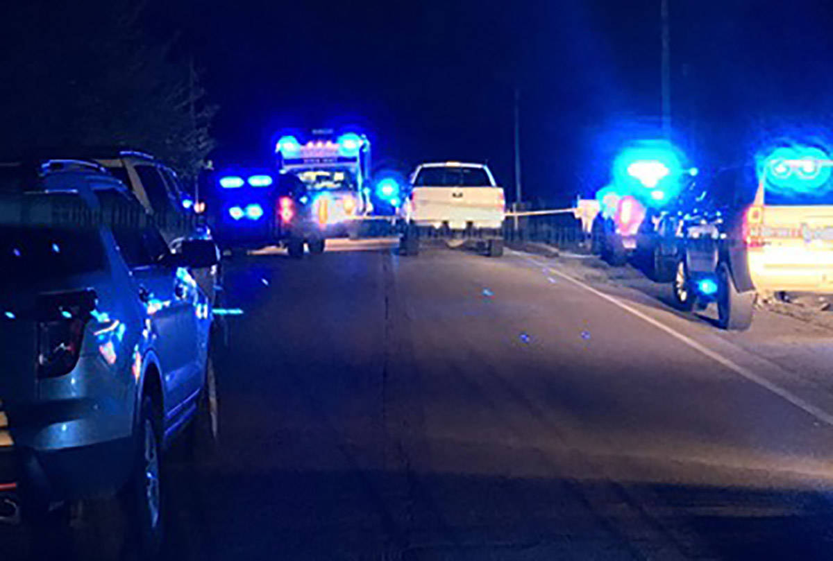 Police units respond to the scene where seven people were found shot to death inside a burning ...