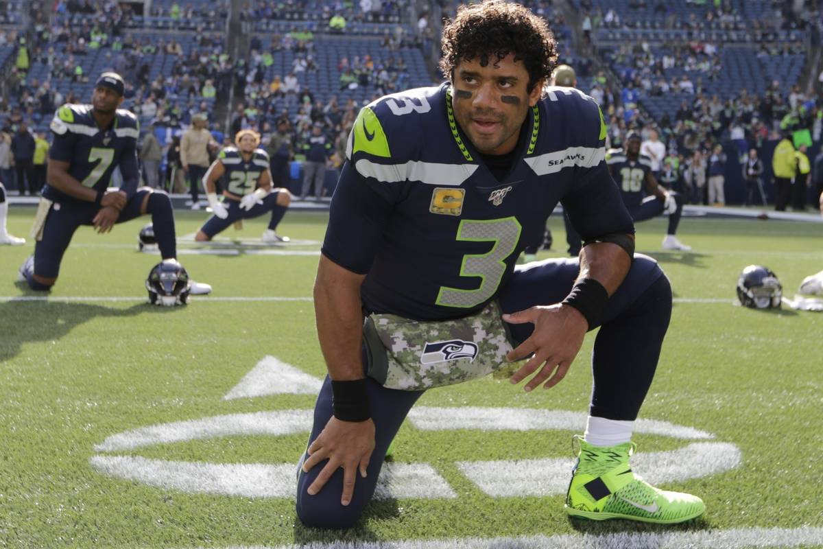 Seattle Seahawks quarterback Russell Wilson stretches before an NFL football game against the T ...