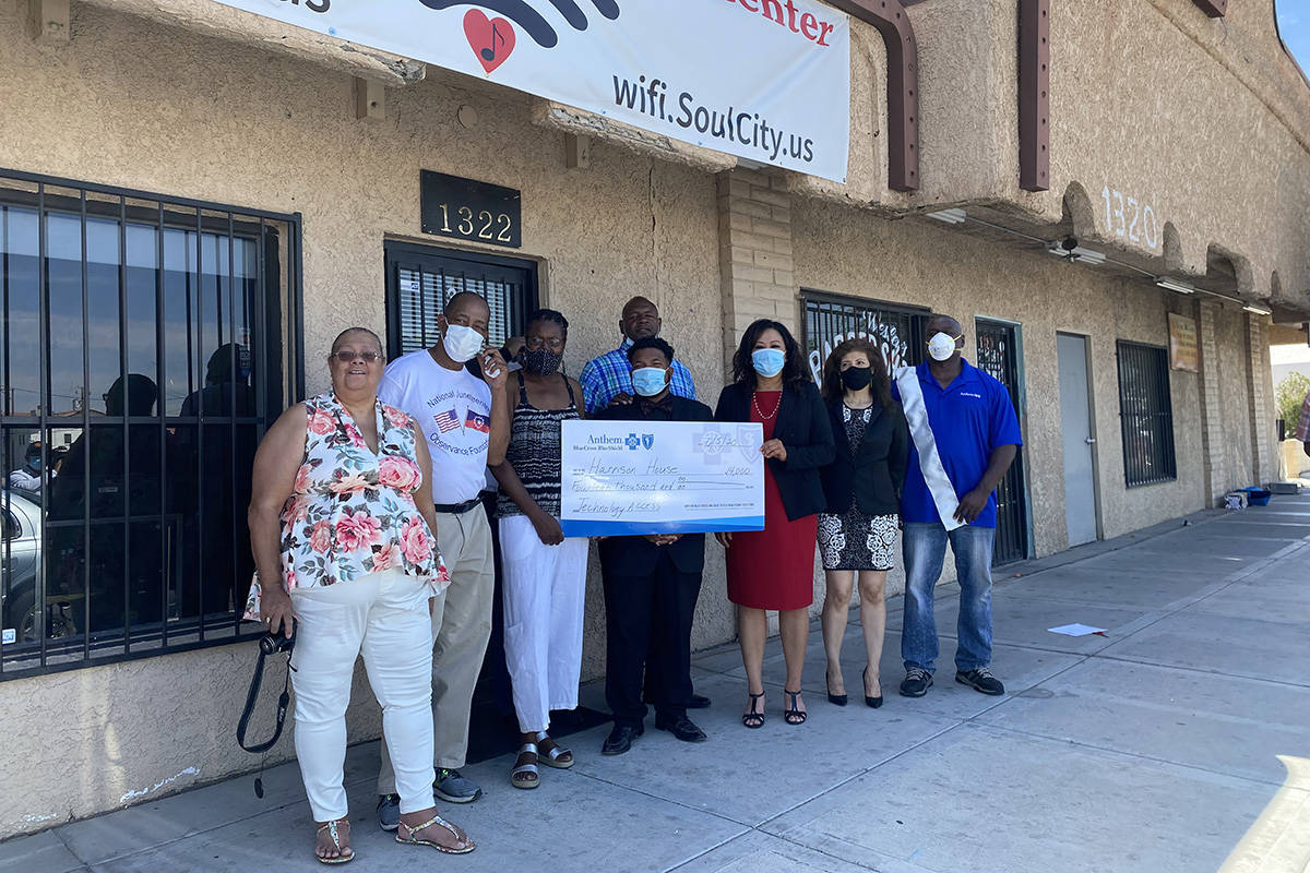 Members of the Soul City WiFi team in front of the Las Vegas Technology Center holding a check ...
