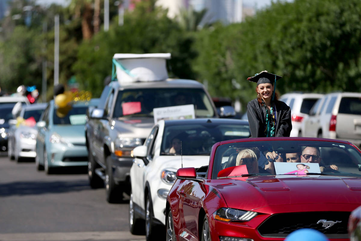 Avery Gosdis, 18, looks out a car as she waits to graduate during a Las Vegas Academy drive-thr ...