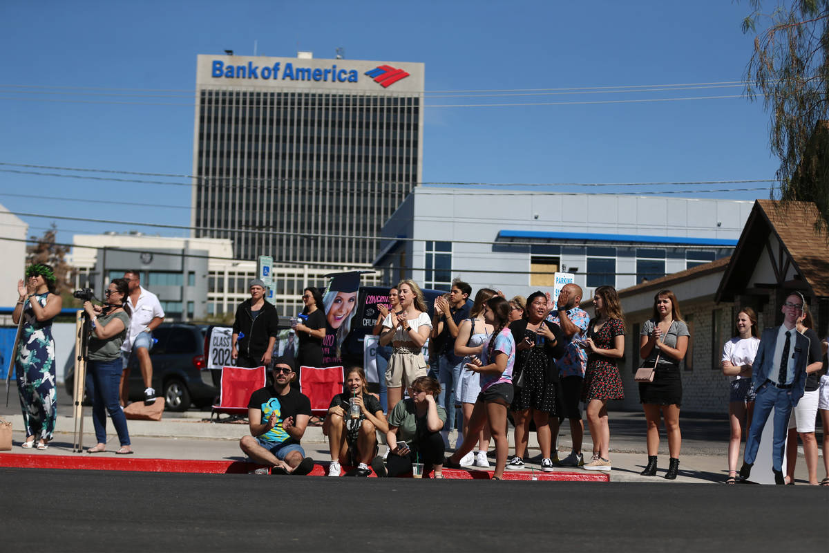 People attend the Las Vegas Academy drive-through graduation in Las Vegas, Saturday, June 6, 20 ...