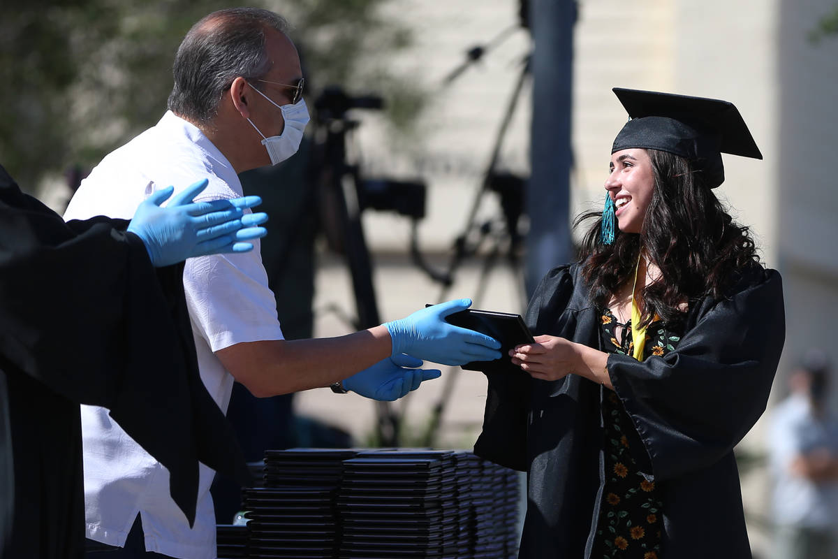 Senior Jaklyn Kittredge, right, receives her diploma from CCSD Superintendent Jesus Jara during ...