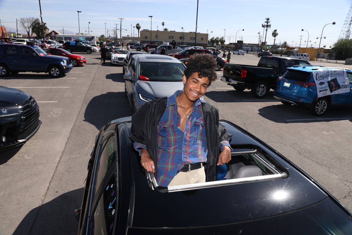 Ricky Edwards, 18, looks out the roof of a car before his drive-through graduation from Las Veg ...