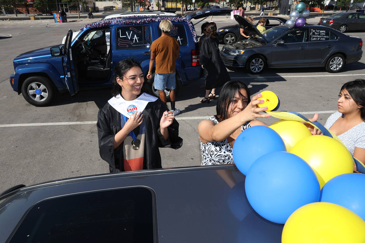 Alejandra Castellanos, 18, with her mother Angie and sister Valerie, 13, decorate their car bef ...