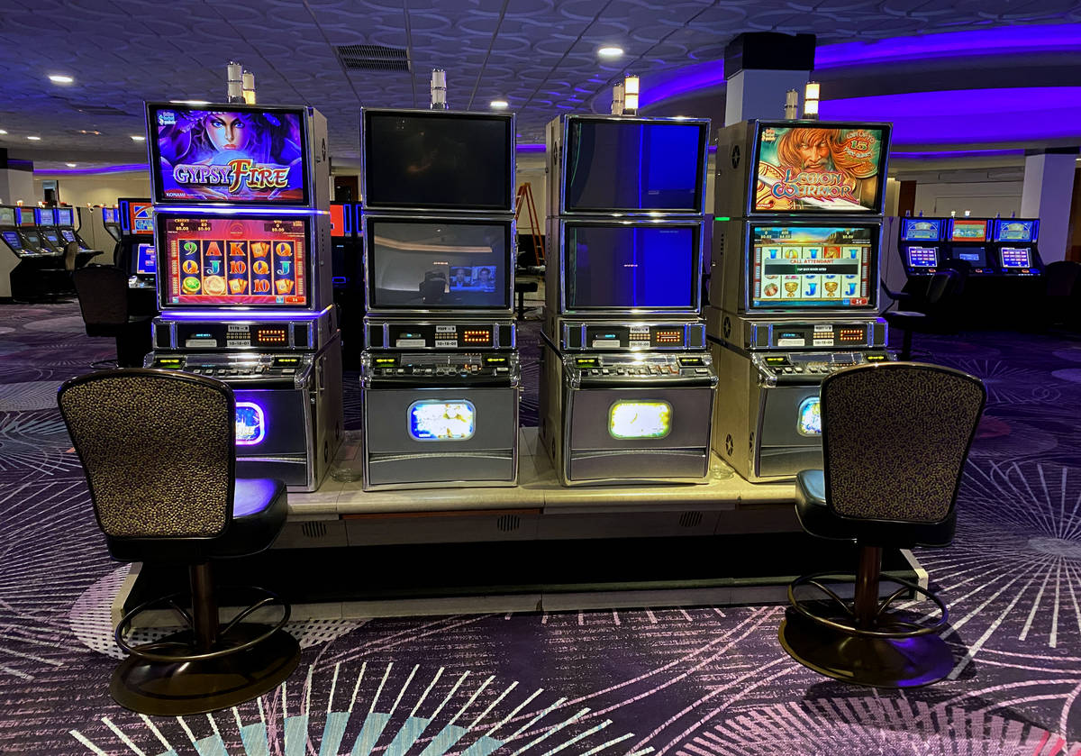 Slot machines at Harrah's are staged for social distancing as they are open for business again ...