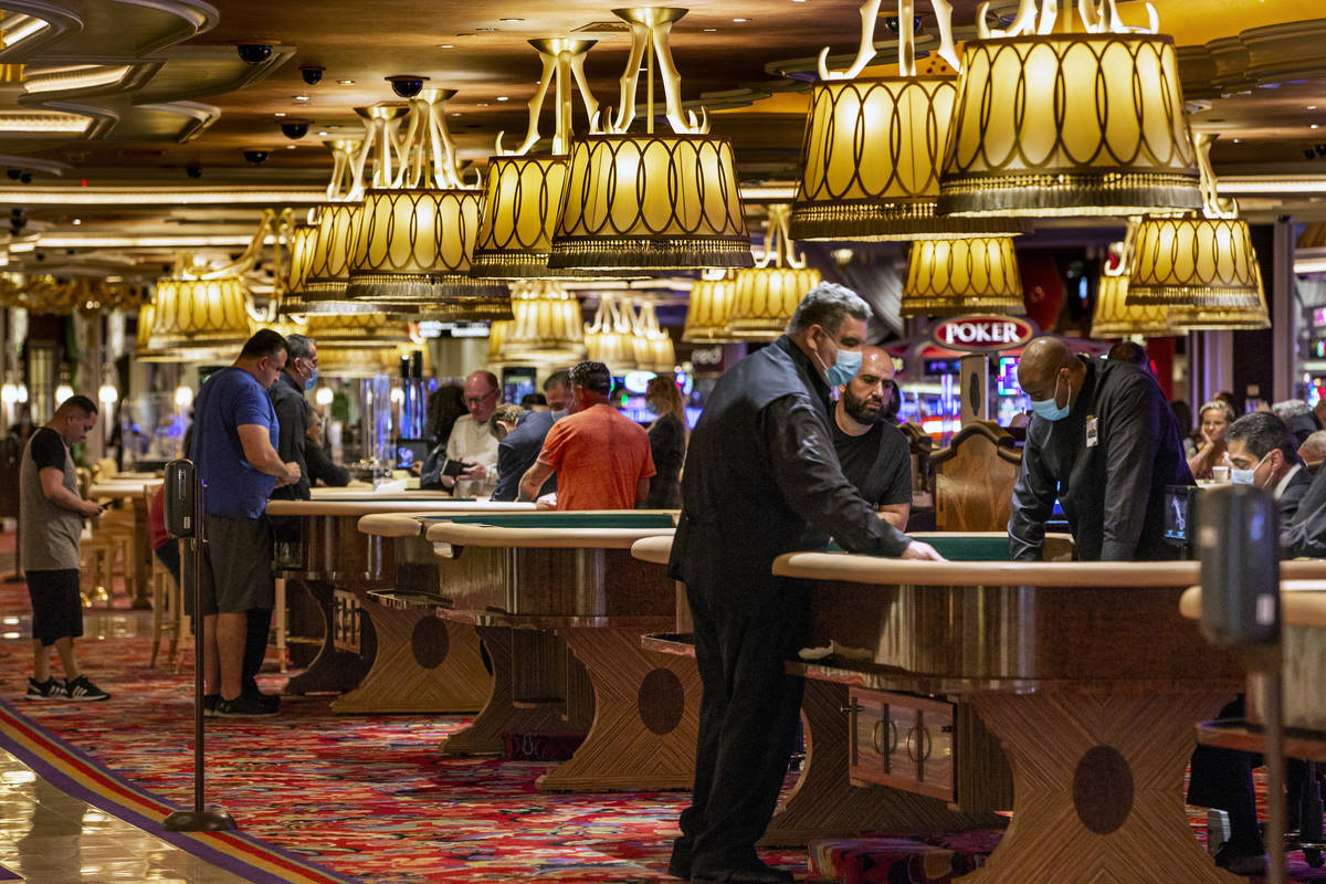 Wynn Las Vegas guests gamble at their tables while Gov. Steve Sisolak tours the casino to view ...
