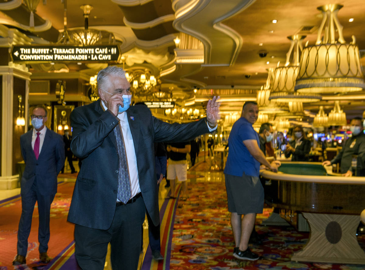 Gov. Steve Sisolak gives a thumbs up to casino guests during a tour with Wynn Las Vegas CEO Mat ...