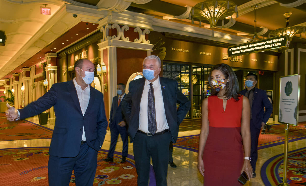 Wynn Las Vegas CEO Matt Maddox, left, talks with Gov. Steve Sisolak and Sandra Morgan, chairwom ...
