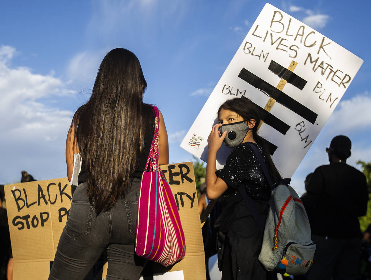 Maya Hernandez, right, 10, and Melissa Sparza listen to a speaker at a Black Lives Matter event ...