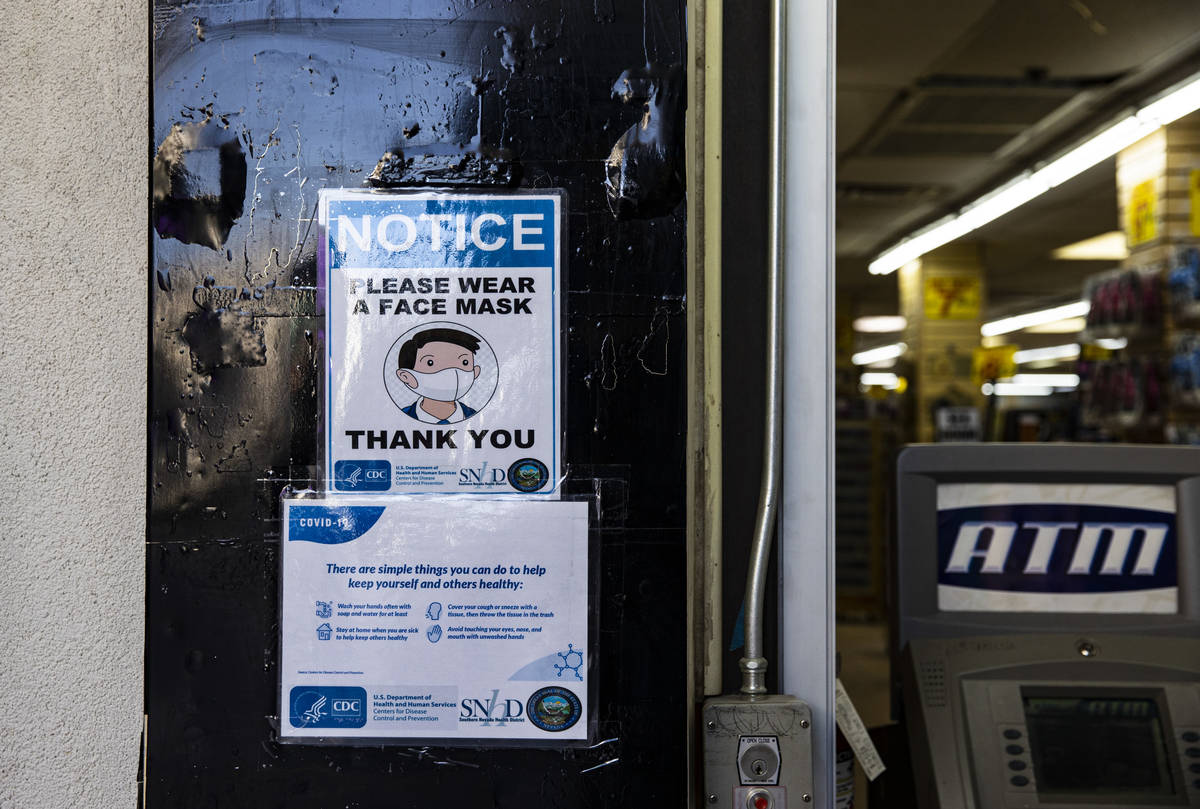 A notice require face masks at a souvenir shop at the Fremont Street Experience in downtown Las ...