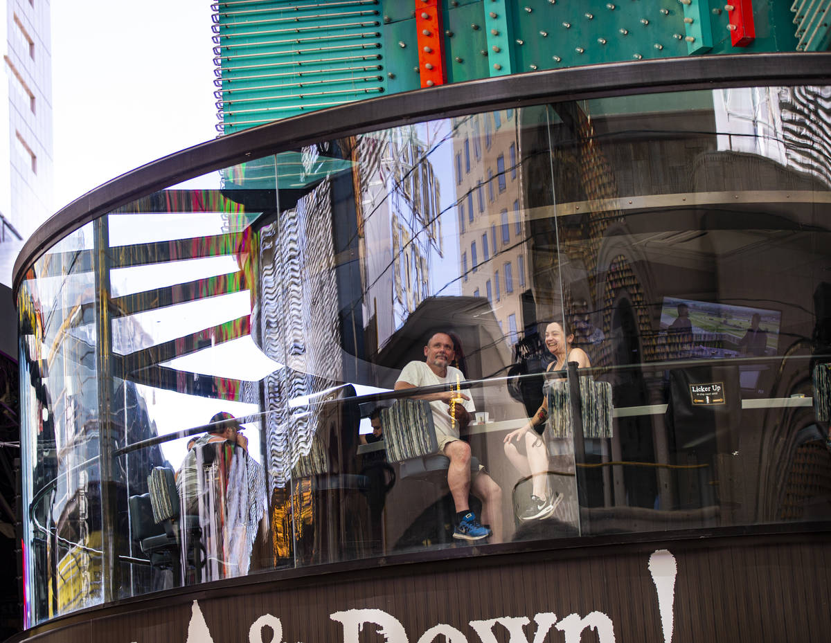 People take in the sights from the Whiskey Licker Up Saloon at the Fremont Street Experience in ...