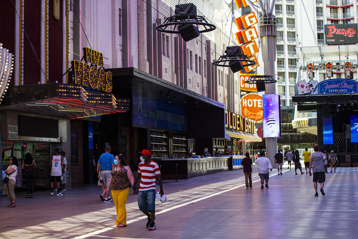 People walk around the Fremont Street Experience in downtown Las Vegas on Saturday, June 6, 202 ...