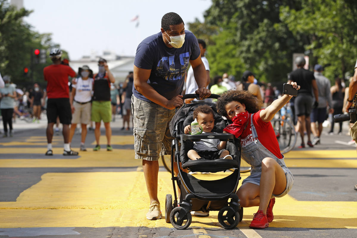 Katie Williams, right, poses for a photo with her son Benjamin, 18 months, and husband Kyle nea ...