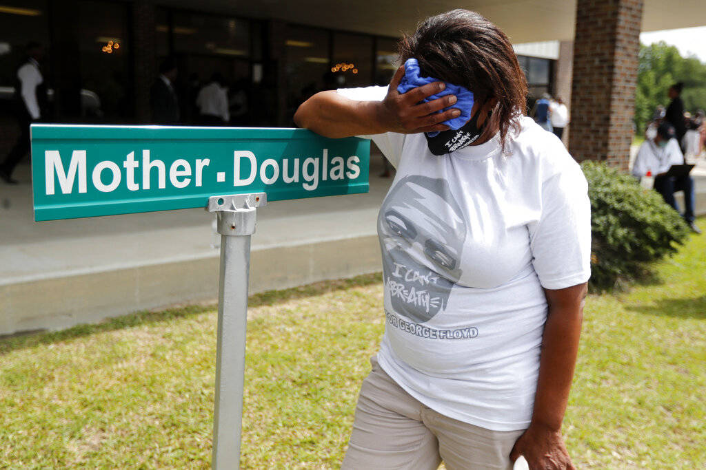 A mourner is overcome with grief after viewing the body of George Floyd during his memorial ser ...