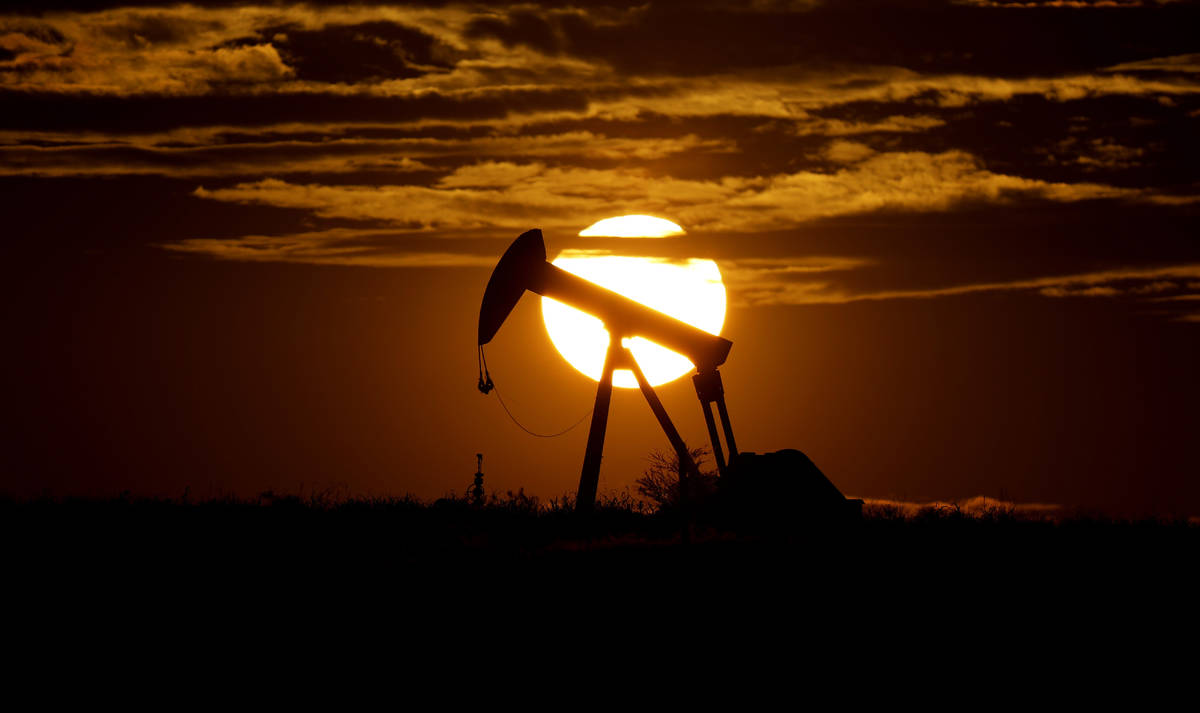 FILE - In this Wednesday, April 8, 2020, file photo, the sun sets behind an idle pump jack near ...