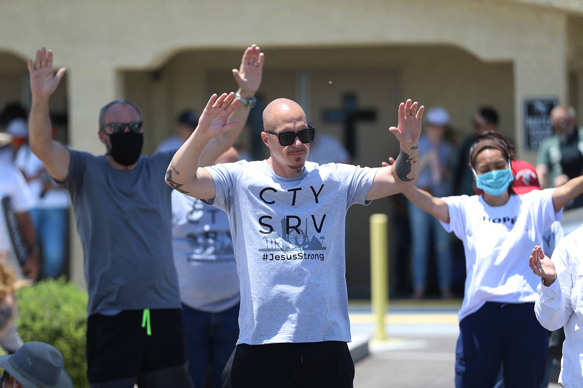 People take a break from a march promoting unity to join in for a prayer outside of the True Lo ...
