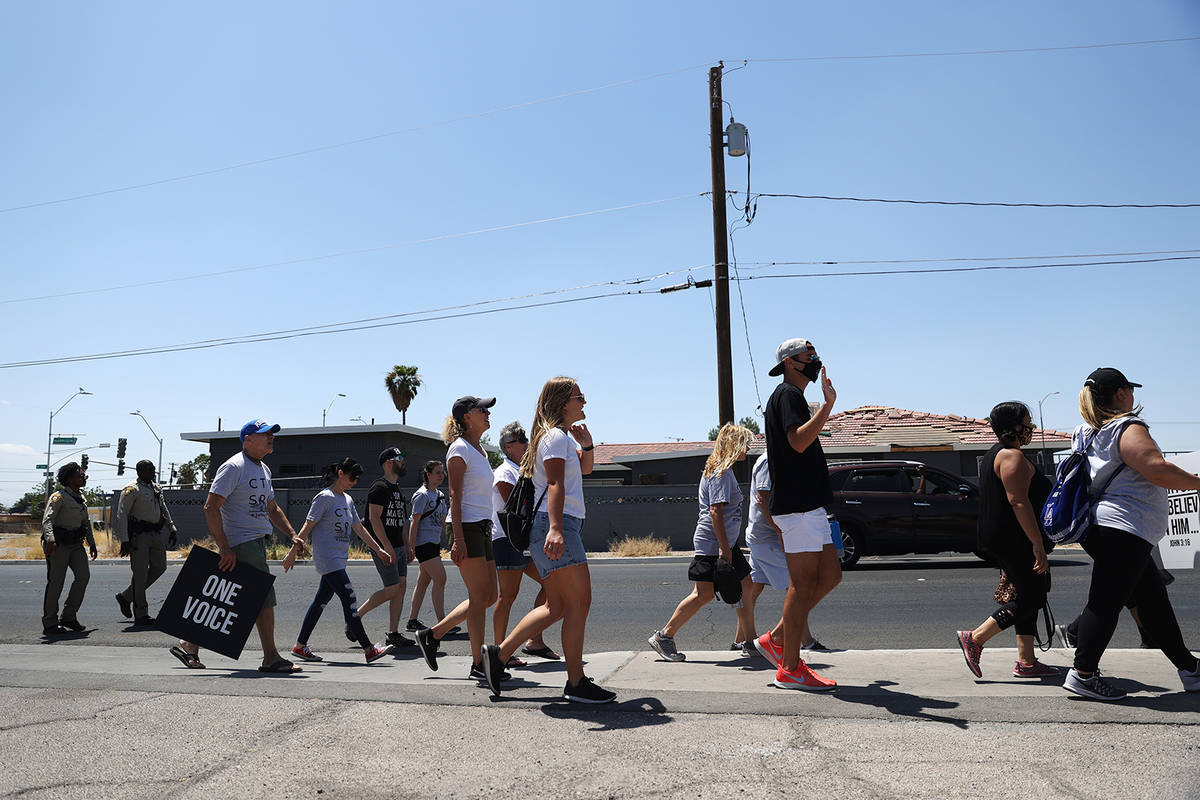 People representing various churches participate in a march on W Owens Avenue and through the H ...