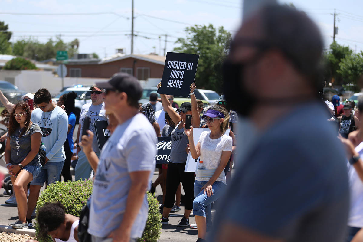 People take a break from a march promoting unity to join in for a prayer outside of the True Lo ...