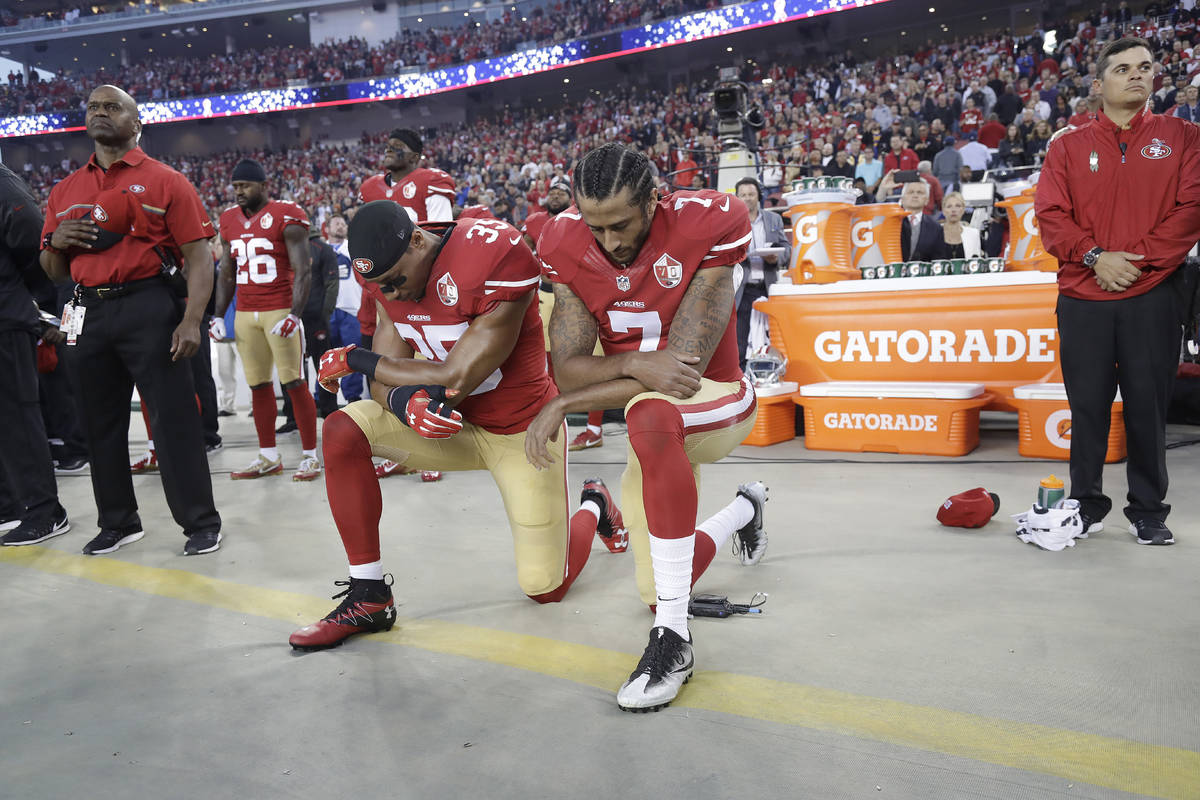 FILE - In this Sept. 12, 2016, file photo, San Francisco 49ers safety Eric Reid (35) and quarte ...