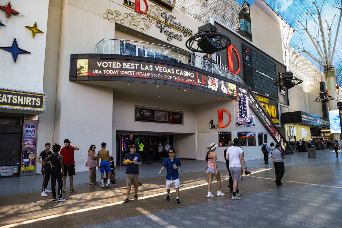 People walk outside of the D Las Vegas at the Fremont Street Experience in downtown Las Vegas o ...