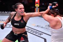 Amanda Nunes, left, of Brazil punches Felicia Spencer of Canada in their featherweight champion ...