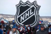 FILE - In this Saturday, Feb. 15, 2020, file photo, fans pose below the NHL league logo at a di ...