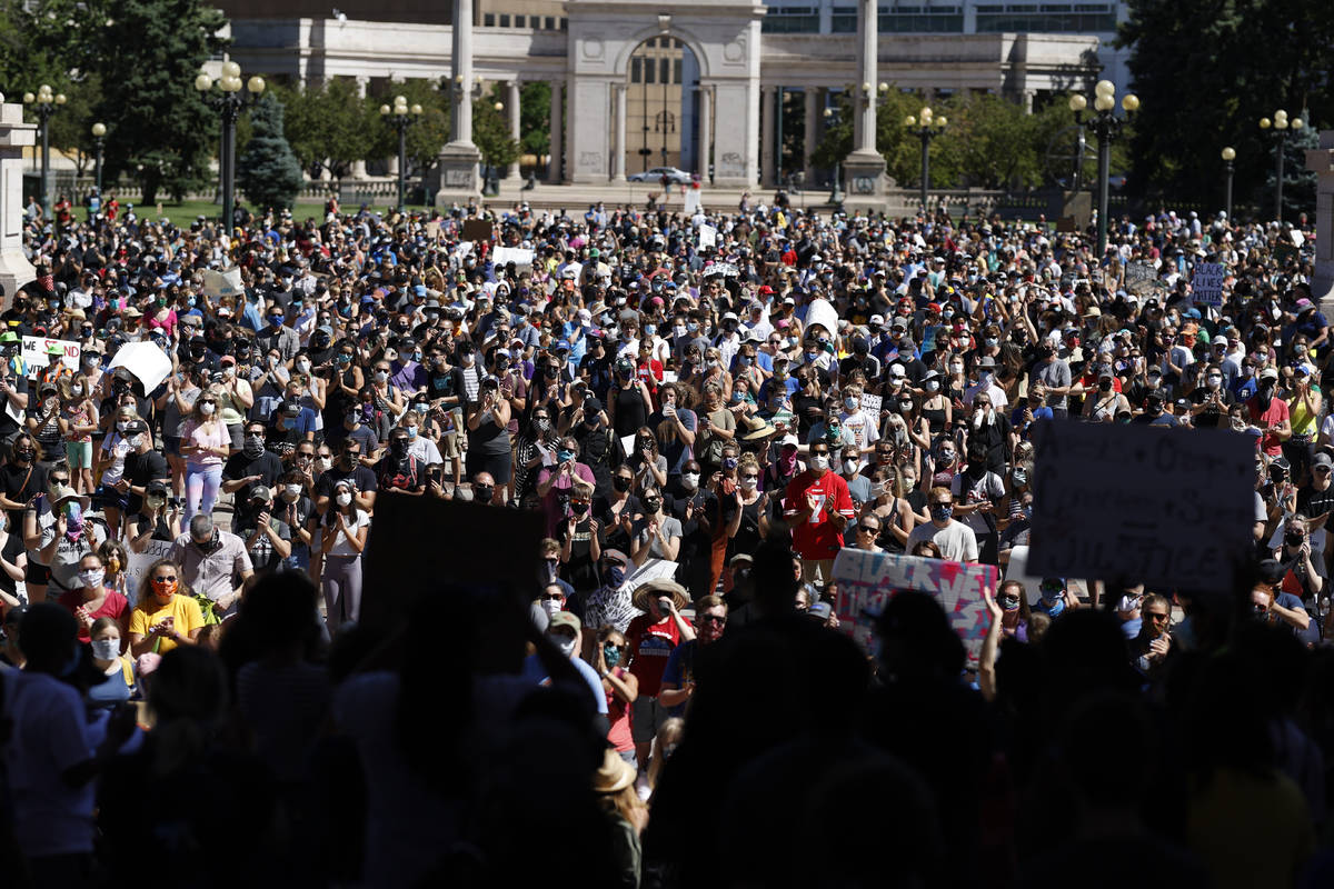 Demonstrators crowd into Civic Center Park during a rally calling for more oversight of the pol ...
