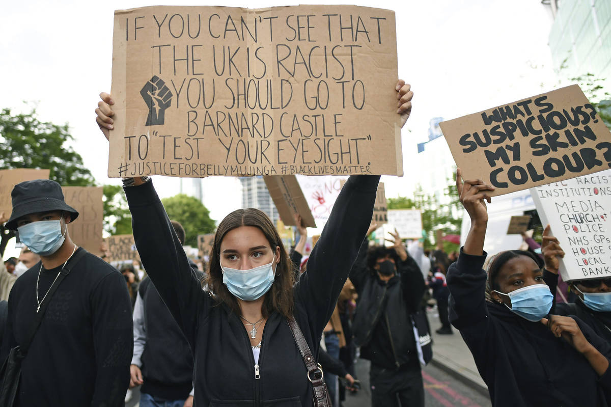 People take part in a Black Lives Matter protest rally outside the US Embassy, in London, Sunda ...