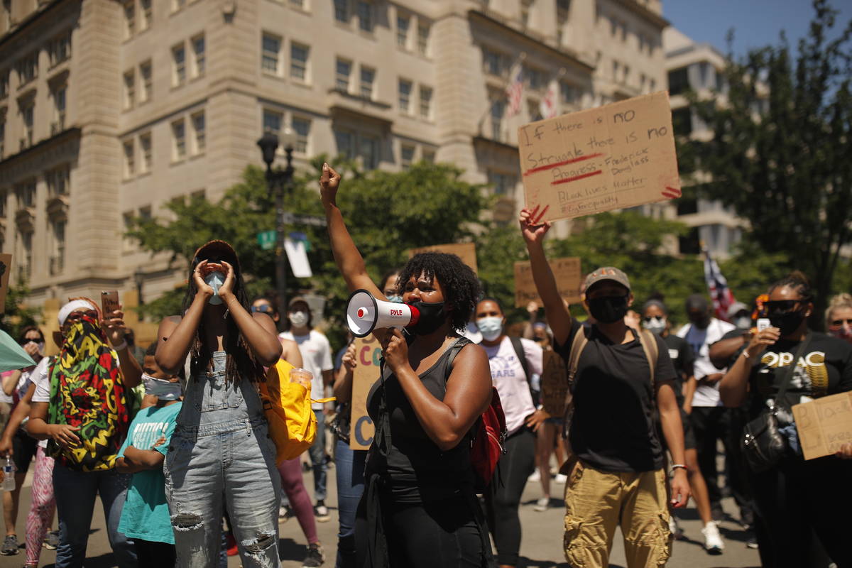 Demonstrators protest Sunday, June 7, 2020, near the White House in Washington, over the death ...