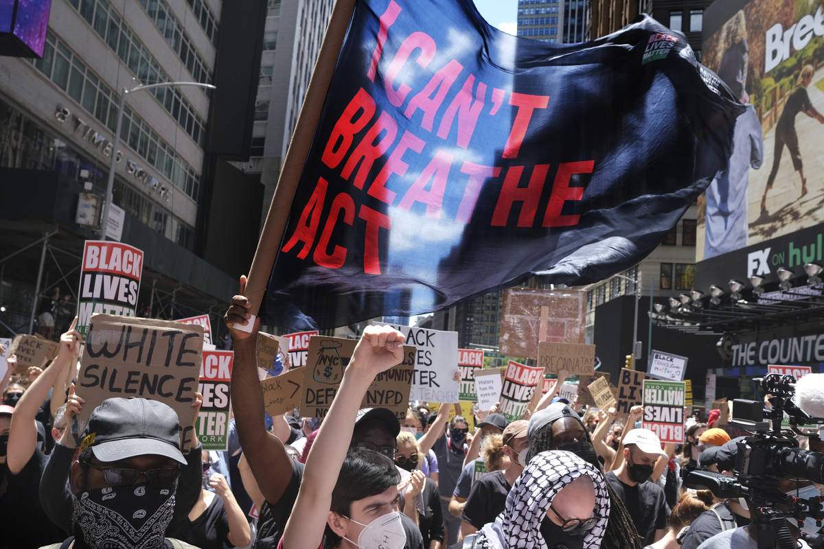Protesters rally near the edge of Times Square in New York, Sunday, June 7, 2020. New York City ...