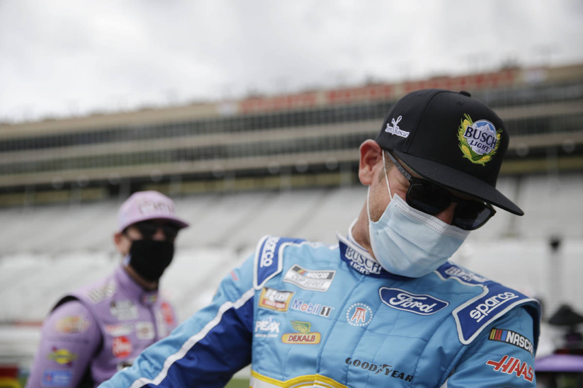 Kyle Busch, left, and Clint Bowyer, right, laugh on pit row before a NASCAR Cup Series auto rac ...