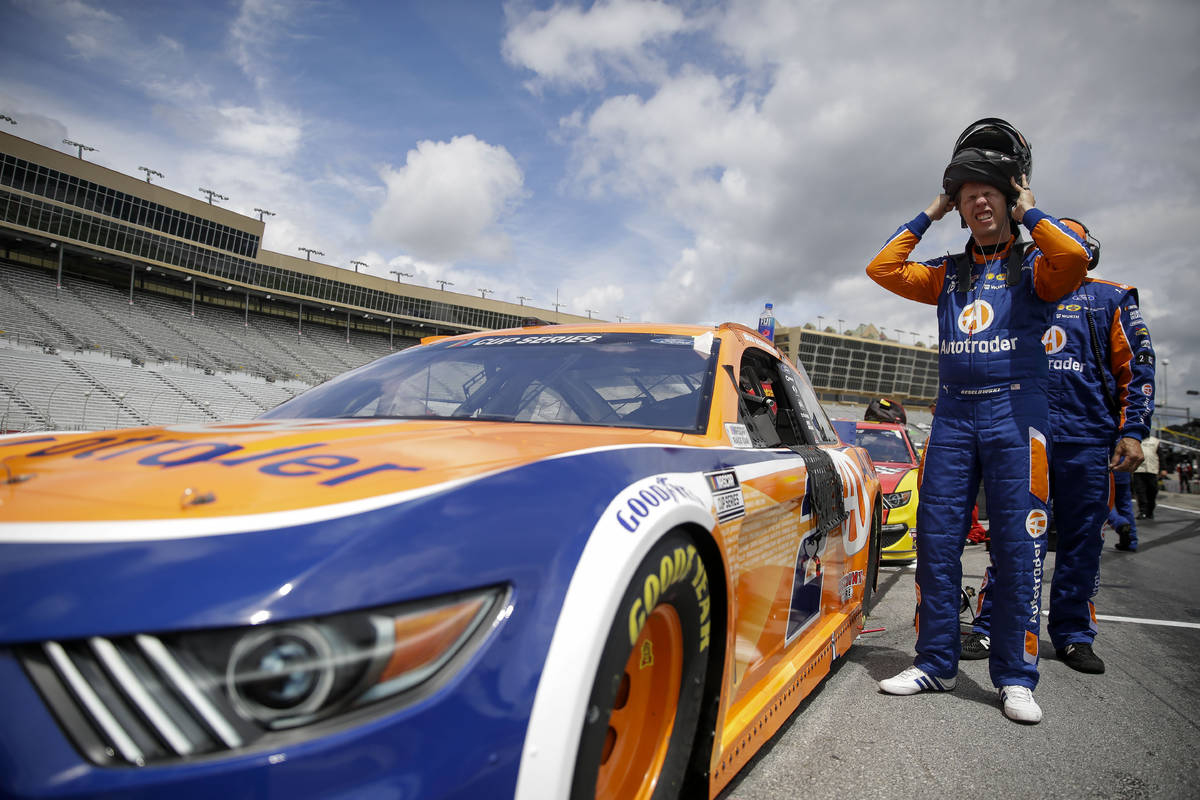 Brad Keselowski puts on a helmet before a NASCAR Cup Series auto race at Atlanta Motor Speedway ...