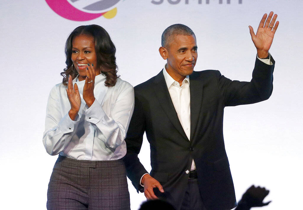 FILE - In this Oct. 31, 2017, file photo, former President Barack Obama, right, and former firs ...