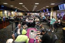 People play poker during the first day of reopening at The Orleans hotel-casino in Las Vegas, T ...