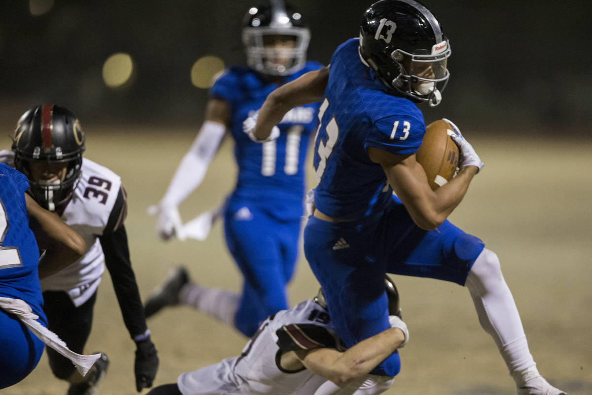 Desert Pines junior wide receiver Michael Jackson (13) makes a big run past Faith Lutheran juni ...