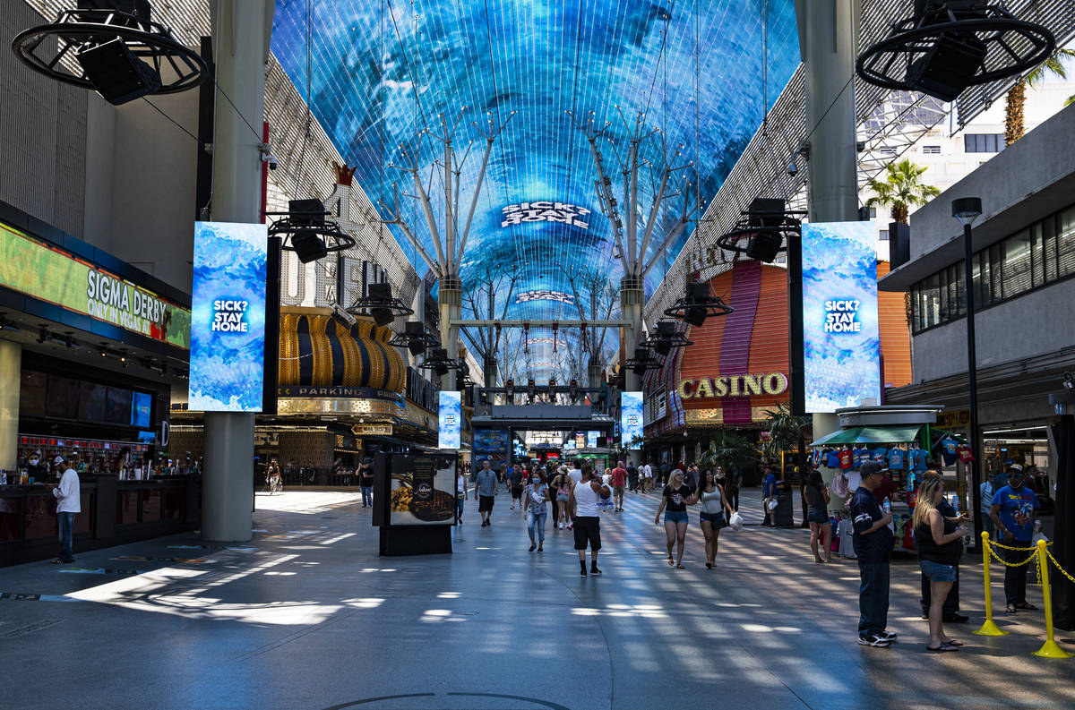 Health and safety messages are displayed at the Fremont Street Experience in downtown Las Vegas ...
