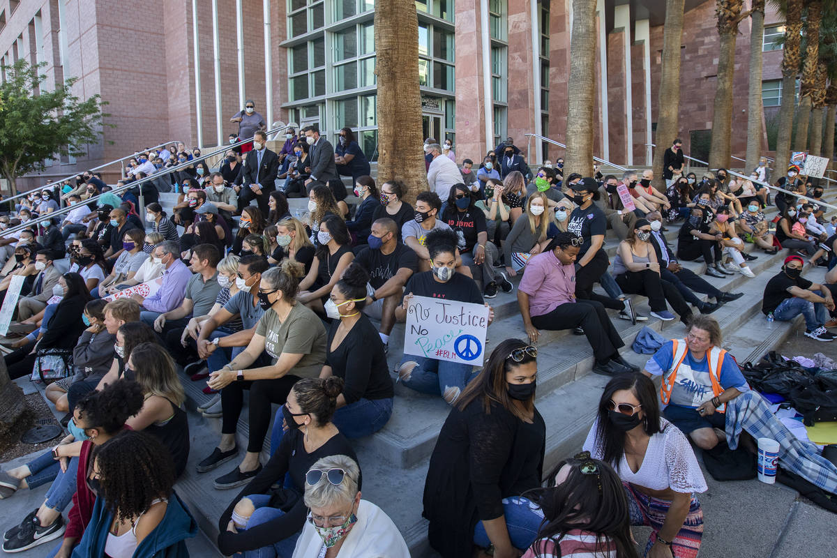A group of public defenders and others gathered for an 8-minute, 46-second moment of silence ou ...
