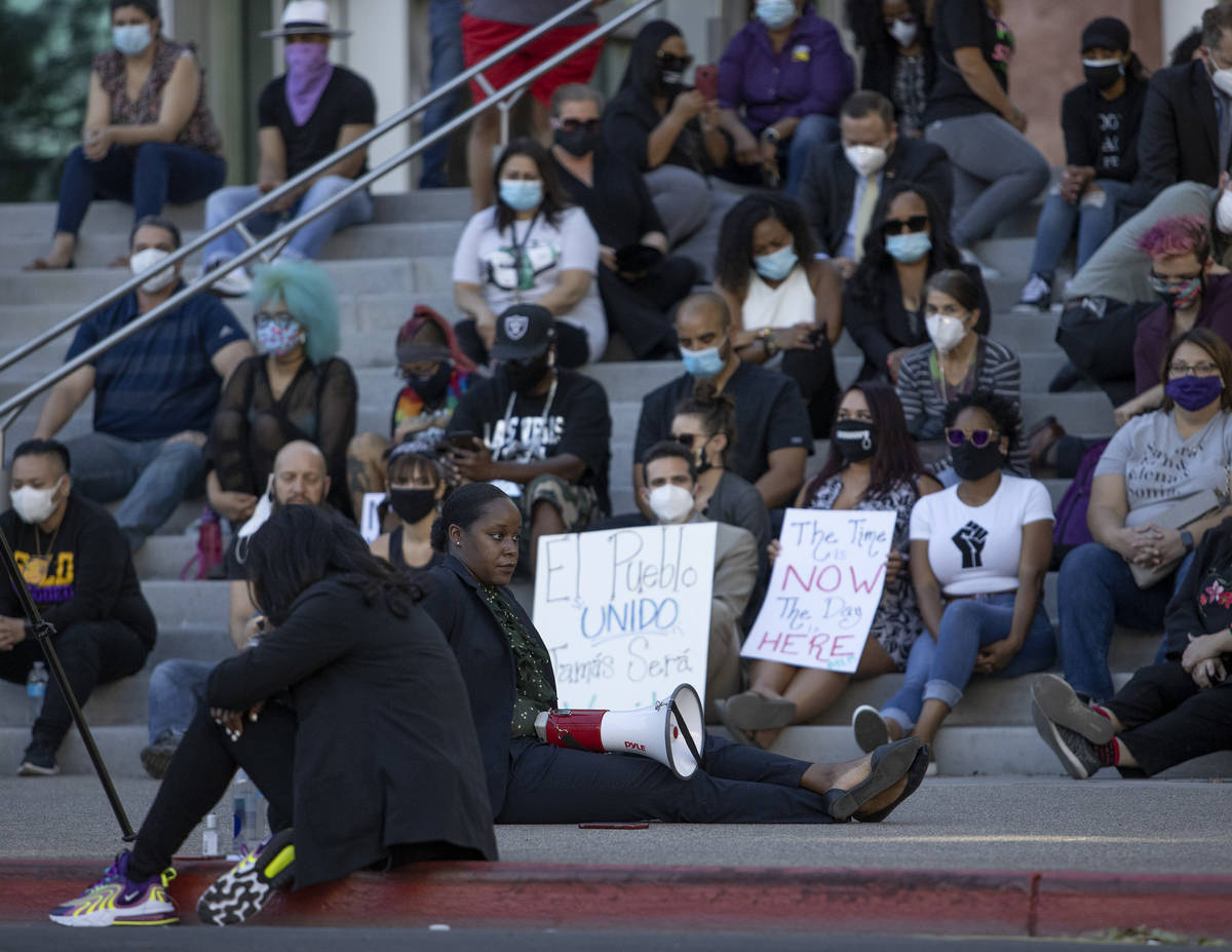 Jessica Smith-Peterson sits in silence after speaking George Floyd's last words to a group taki ...