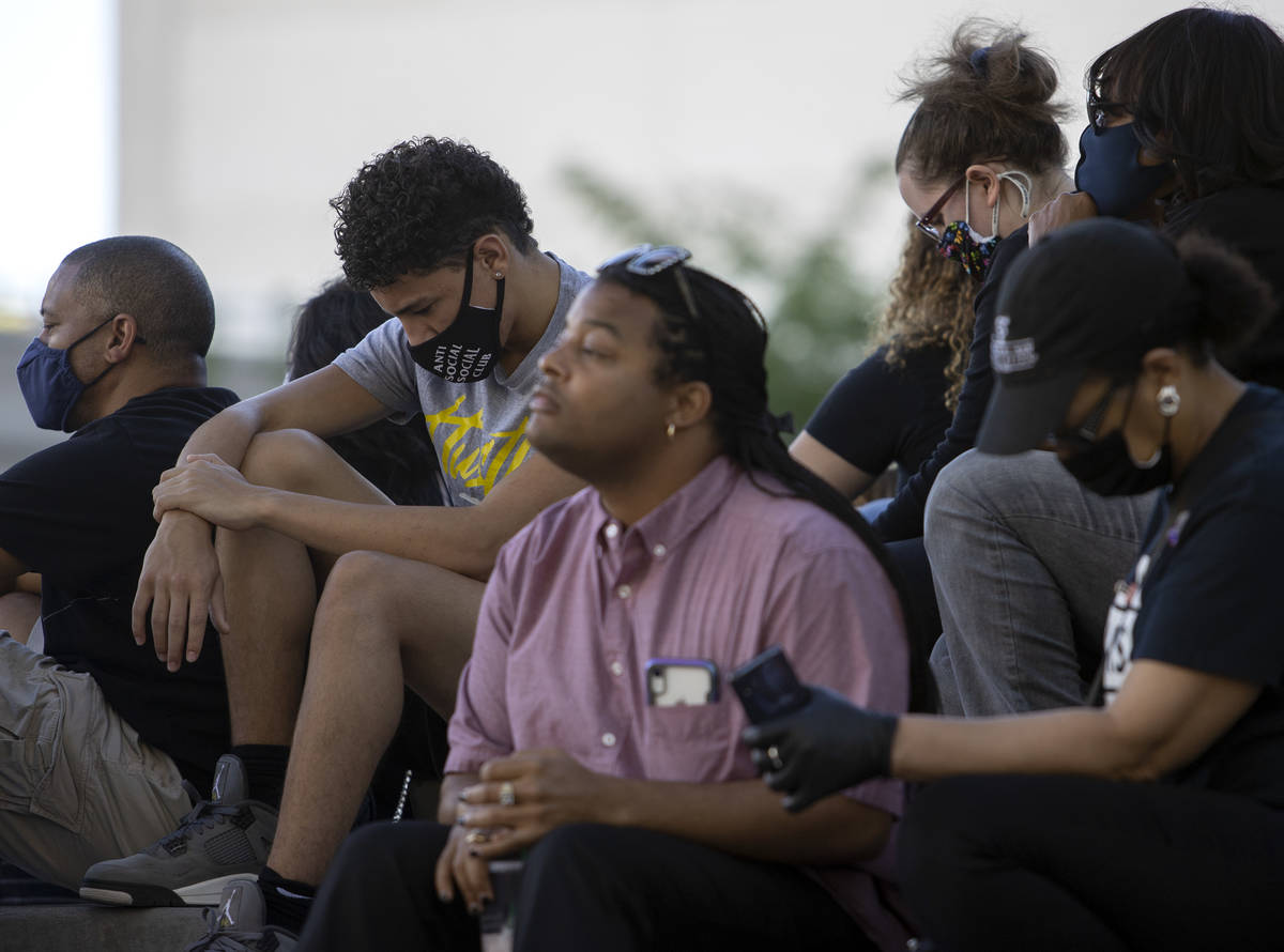 A group of public defenders and others gathered for an 8-minute, 46-second moment of silence in ...