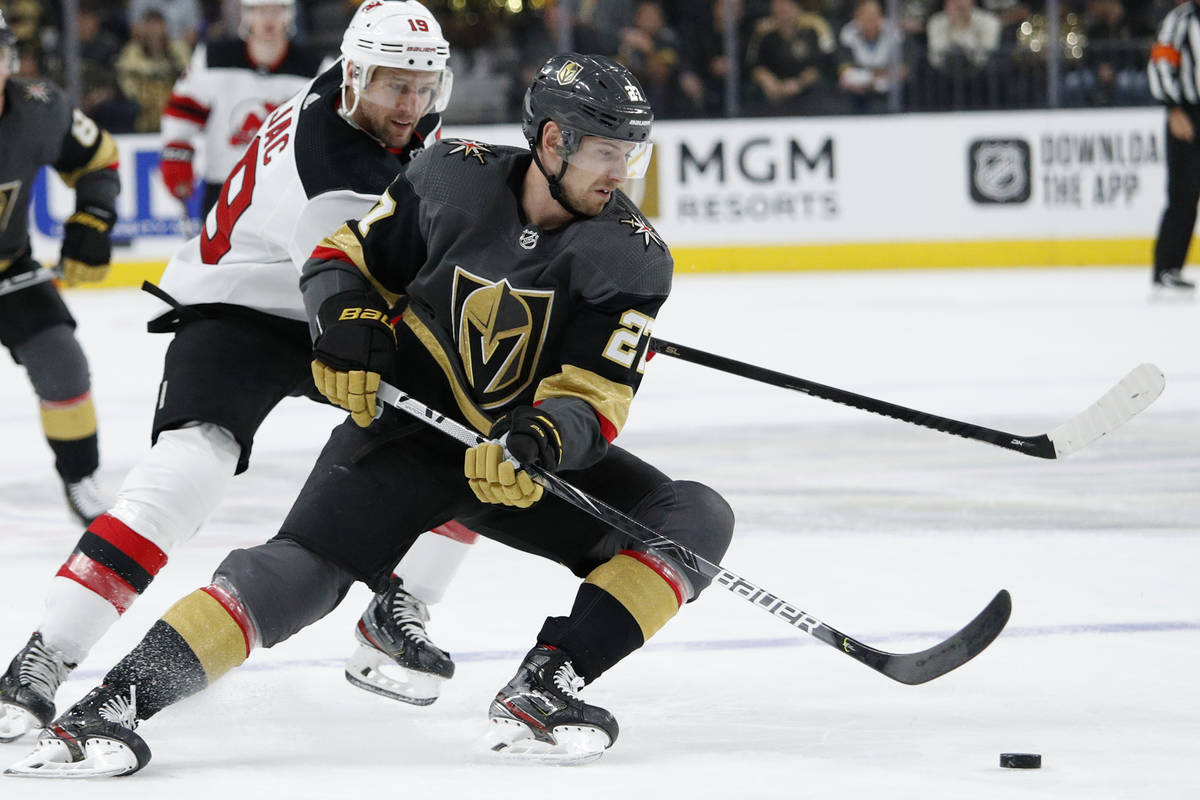 Vegas Golden Knights defenseman Shea Theodore (27) skates around New Jersey Devils center Travi ...