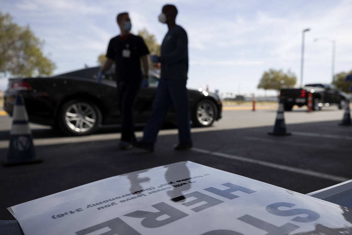 Signs directing patients where to go at a COVID-19 testing site also have bible passages at Cal ...