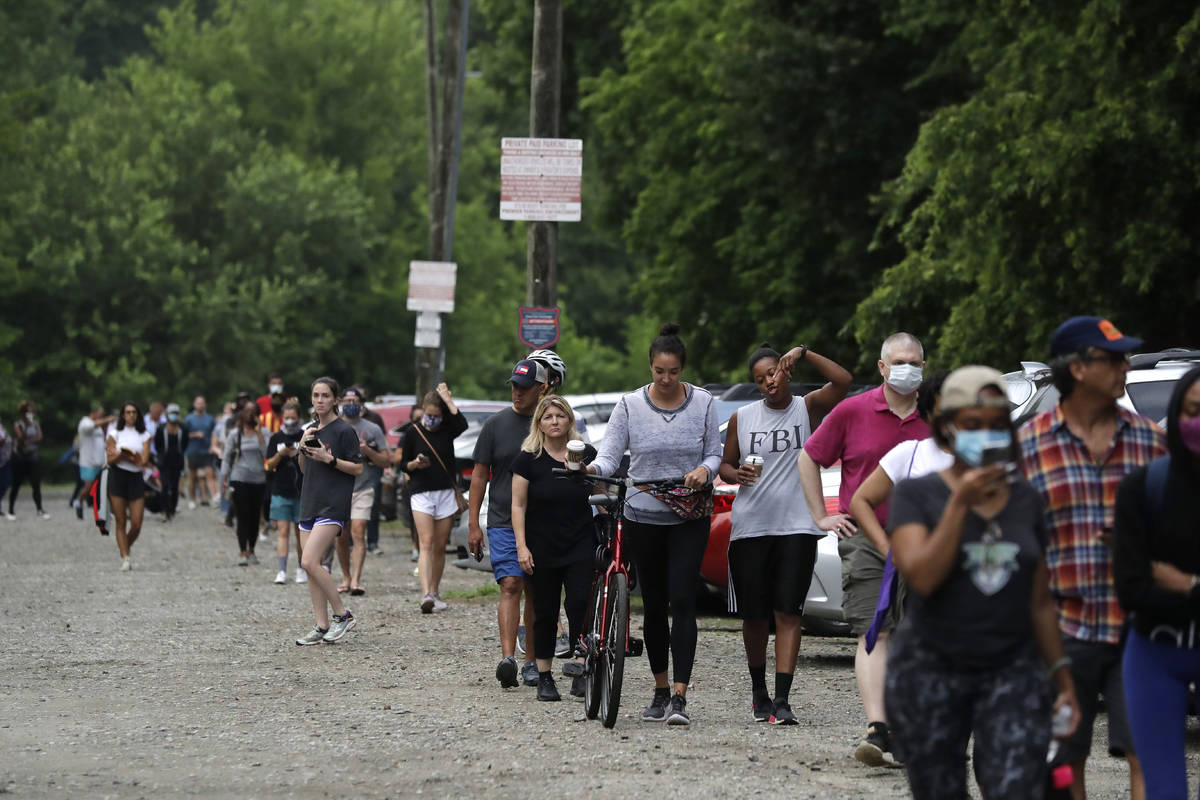 People wait in line to vote in the Georgia's primary election at Park Tavern on Tuesday, June 9 ...
