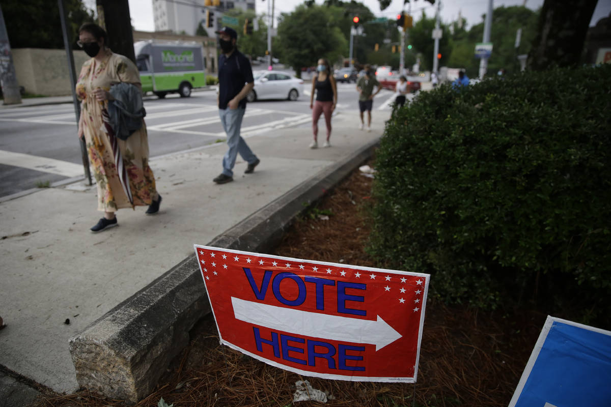 People wait in a line to vote in the Georgia's primary election at Park Tavern on Tuesday, June ...