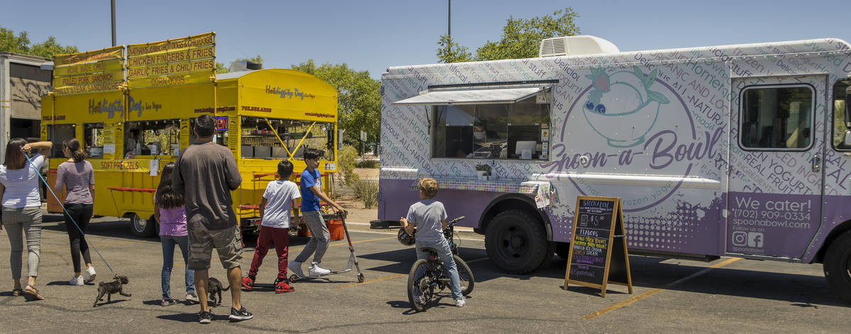 The Hot Diggity Dog Las Vegas and Spoon-a-Bowl food trucks serve customers about Desert Breeze ...