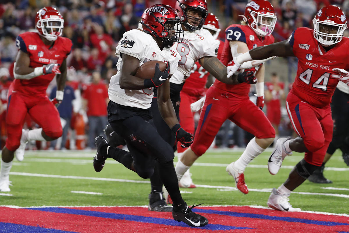 UNLV running back Charles Williams tries to get around Fresno State defensive lineman Leevel Ta ...