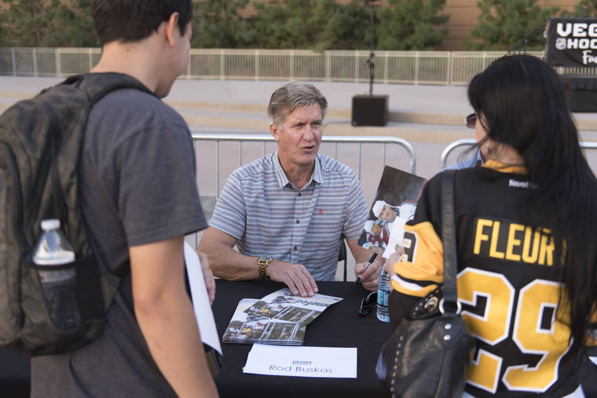 Retired NHL player Rod Buskas signs autographs during the Vegas Hockey Fan Fest at Toshiba Plaz ...