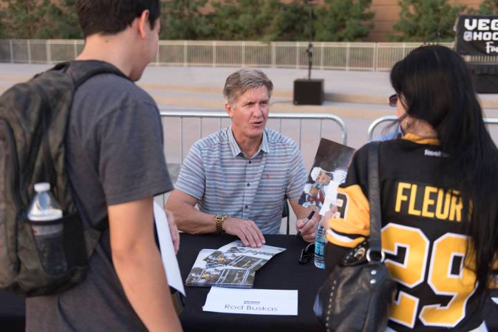 Retired NHL player Rod Buskas signs autographs during the Vegas Hockey Fan Fest at Toshiba Plaz ...